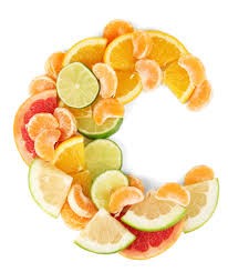 Orange and lemon slices arranged in a C shape