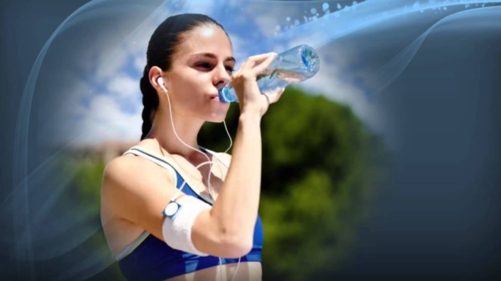 A female athlete drinking water from a water bottle
